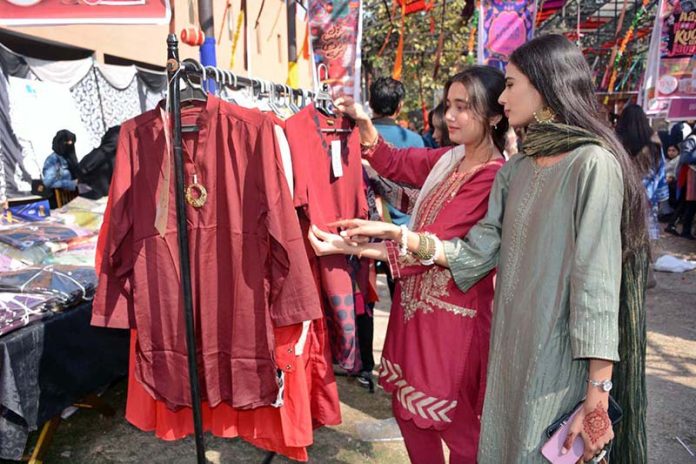 Students are visiting stalls during Punjabi Cultural Day and the 5th Annual Book Fair at Government College Women University Faisalabad (GCWUF)