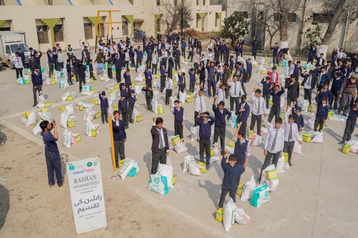 School children after receiving their part during Rashan Distribution by Allah Wale Foundation at National Special Education Centre for Hearing Impaired Children