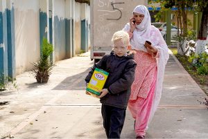 School children after receiving their part during Rashan Distribution by Allah Wale Foundation at National Special Education Centre for Hearing Impaired Children