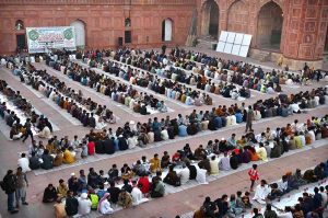 A large number of people wait for the Maghrib Azan before breaking their fast with iftar meals during the holy fasting month of Ramazan at the historical Badshahi Mosque in the provincial capital