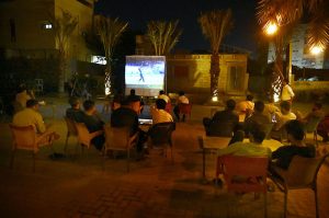 People watch and enjoy the T20 cricket match between Pakistan and India on big screen at defense area