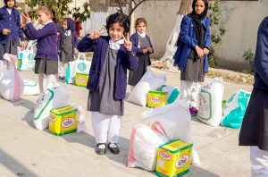 School children after receiving their part during Rashan Distribution by Allah Wale Foundation at National Special Education Centre for Hearing Impaired Children