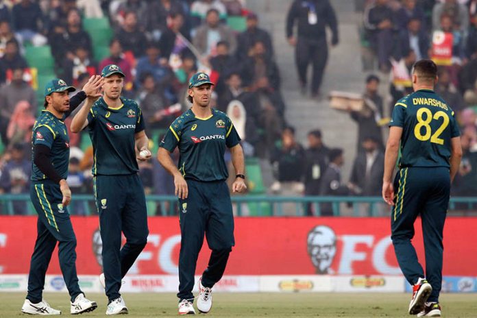 Australian players celebrate after the dismissal of Pakistan's (Salman Agha catch Green ball by Dwarshuis) during the third Twenty20 international cricket match between Pakistan and Australia at the Gaddafi Cricket Stadium