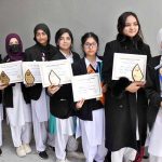 Winner students of the flower arrangement and card making competitions pose for a group photo with their certificates and trophy during an intercollegiate ceremony held at Model College for Girls, I-14/3