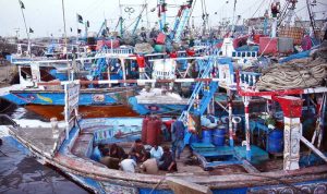 Fishermen break their fast on their boats at the fishery area during holy month of Ramazan.