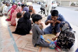 People break their fast during Free Iftar at the roadside in the city during the holy fasting month of Ramazan.
