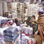 A customer selects and purchases prayer caps at Chowk Yadgar ahead of the holy month of Ramadan.