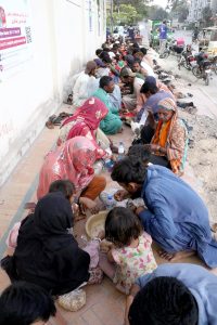 People break their fast during Free Iftar at the roadside in the city during the holy fasting month of Ramazan.