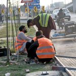 Workers busy in repair and maintenance work in the city