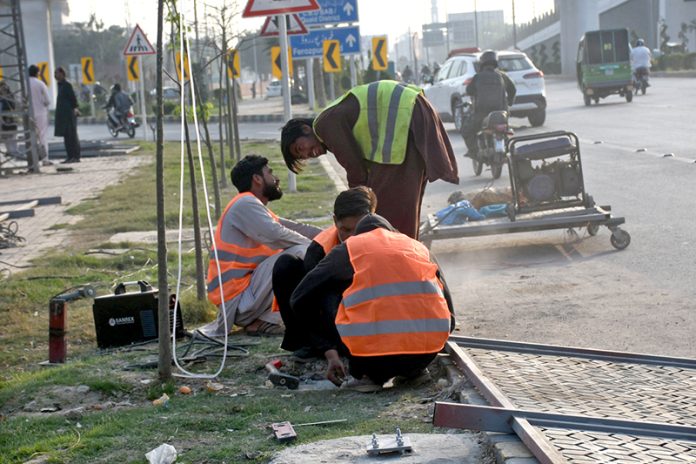 Workers busy in repair and maintenance work in the city