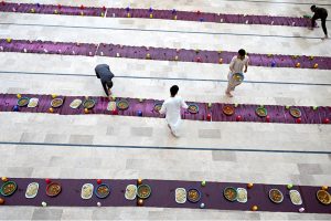 A volunteer distribute Dates in Iftar during the Holy Fasting Month of Ramzan at Muhammadi Masjid.
