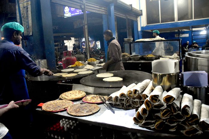 Workers are gearing up to meet the increased demand for Sehri ka paratha items during the holy month of Ramazan in the provincial Capital