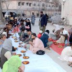 People gather for the first Iftar of Ramazan at the roadside