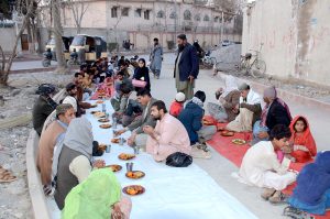 People gather for the first Iftar of Ramazan at the roadside
