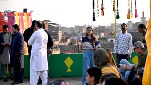 People enjoy flying kites during celebrations of the three-day kite-flying festival “Basant” in the Walled City, marking its return to the provincial capital after two decades under strict administrative control