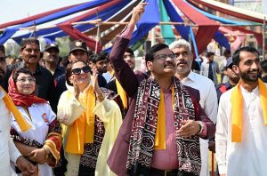 Students poses with a kite during the Basant Bahar Festival at Chandka Medical College
