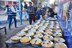 Volunteers distribute free Iftar for the common people to break their fast in the Islamic holy month of Ramazan, at Latifabad