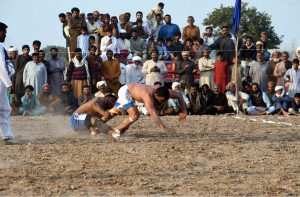 Players in action during Takreem Shuhada kabaddi match as spectators gather in large numbers to witness the traditional sport at a local ground