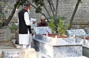 People recite the Holy Quran and offer Fatiha at the graves of their relatives on the occasion of Shab-e-Barat.