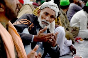 A volunteer prepares and arranging the plates of Iftar food free for the common people to break their fast on the first day of the Islamic holy month of Ramazan, at the Data Darbar shrine in the Provincial Capital
