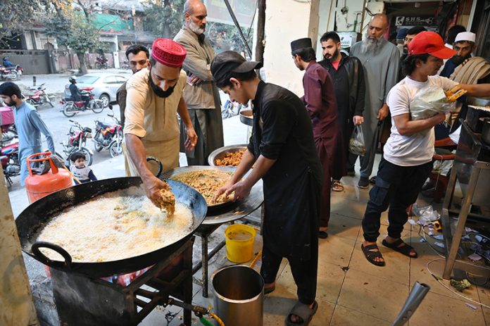 A vendor preparing traditional food item Pakora (fritter) for Iftar in the holy fasting month of Ramazan at I-10 Markaz
