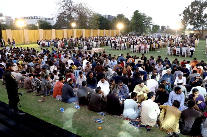 A large number of people break their fast during Iftar dinner reception to the common people under Umeed Ramazan at the Governor's House