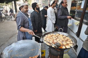 A vendor preparing traditional food item Pakora (fritter) for Iftar in the holy fasting month of Ramazan at I-10 Markaz