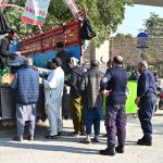 People purchase flour bags from a distributing point provided by provincial government
