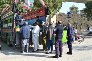 People purchase flour bags from a distributing point provided by provincial government
