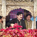 Sindh Chief Minister Syed Murad Ali Shah putting flower petals after laying wreath on the grave of Hazrat Lal Shahbaz Qalandar on the last day occasion of 774th Urs celebration