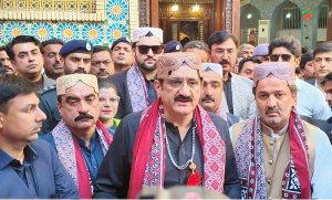 Sindh Chief Minister Syed Murad Ali Shah putting flower petals after laying wreath on the grave of Hazrat Lal Shahbaz Qalandar on the last day occasion of 774th Urs celebration