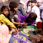 People break their fast during Free Iftar at the roadside in the city on the 2nd day of holy fasting month of Ramazan