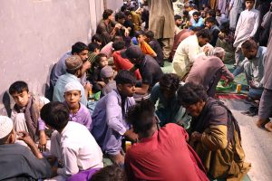 People break their fast during Free Iftar at the roadside in the city on the 2nd day of holy fasting month of Ramazan