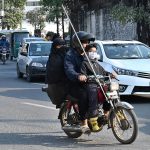 On the first day of Basant, a family rides a motorcycle equipped with a safety rode as they head to their destination, following stringent safety measures during the festival’s return to the provincial capital after the ban was lifted after two decades