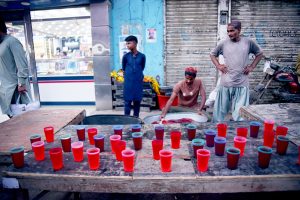 A large number of people break their fast during Iftar organized by Chhipa Welfare Free Food Dastarkhawan at the roadside in the city during the holy fasting month of Ramazan