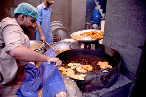 A vendor prepare Jalebi to sell for Iftar at Burns Road