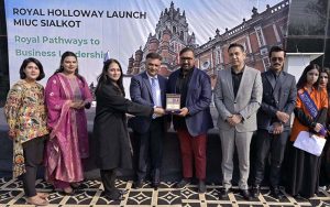 Syed Ahtesham Mazhar, President of Sialkot Chamber of Commerce & Industry (SCCI), receives a shield at Roots International Schools & Colleges (RISC) and Metropolitan International United College (MIUC).