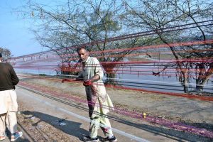 A vendor making kite strings by applying manja as Punjab government announces the celebration of the traditional event Basant 2026