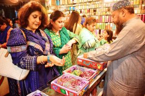 Women are busy selecting and purchasing bangles from a shop at local market in connection with upcoming Eidul Fitr.