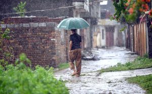 Youngsters playing in the rain water in the street after rain that experienced the Federal Capital.