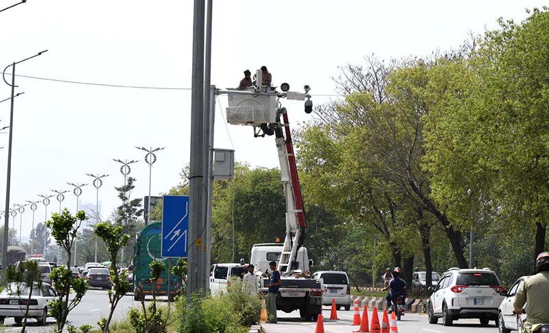 Workers are seen busy installing security cameras in Bhara Kahu to enhance surveillance