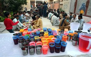 A man distributes iftar meal to fasting people outside his home, embodying the spirit of sharing and compassion during the holy month of Ramazan in the federal capital.