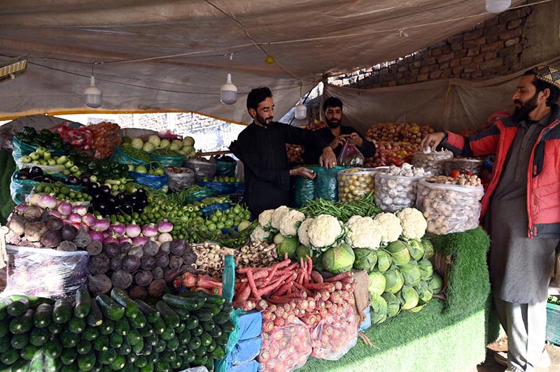 A vendor displaying vegetables to attract customers during holy fasting month of Ramazan near Ghouri town in the Federal Capital
