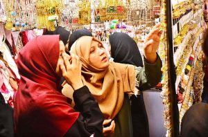 Women are busy selecting and purchasing bangles from a shop at local market in connection with upcoming Eidul Fitr.