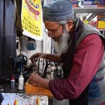 A worker busy repairs a sewing machine at his workshop in the Abpara area of the Federal Capital