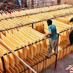 Workers hang vermicelli (seviyan) on bamboo stands for drying after preparation, as demand surges ahead of Eid-ul-Fitr at a local factory in Paretabad during the holy month of Ramazan.