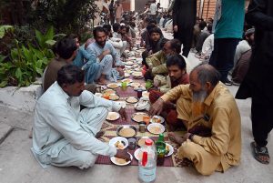A man distributes iftar meal to fasting people outside his home, embodying the spirit of sharing and compassion during the holy month of Ramazan in the federal capital.