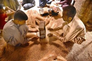 Worker busy arranging and hanging vermicelli (seviyan) on the bamboos stand for drying purpose after preparing it, ahead of Eid-ul-Fitr at local factory.
