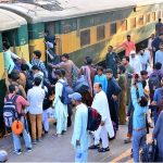 People boarding on train at Railway Station to leave for their hometowns to celebrate Eid-ul-Fitr with their loved ones