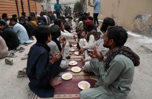 A man distributes iftar meal to fasting people outside his home, embodying the spirit of sharing and compassion during the holy month of Ramazan in the federal capital.